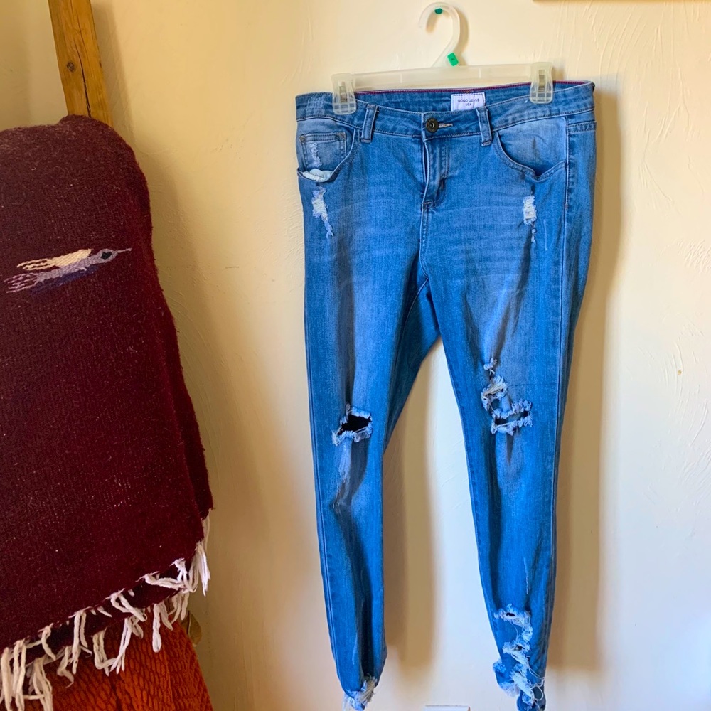 Ripped blue denim jeans.